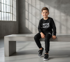 Kids “Never Give Up” Printed Black & Black Tracksuit Set | Winter Fleece Sweatshirt & Trouser Outfit for Boys & Girls – Warm & Motivational FOR BABY AND KIDS
